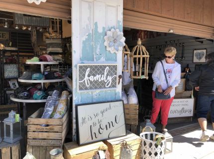 Sign vendors booth display in outdoor Flea Market with shoppers