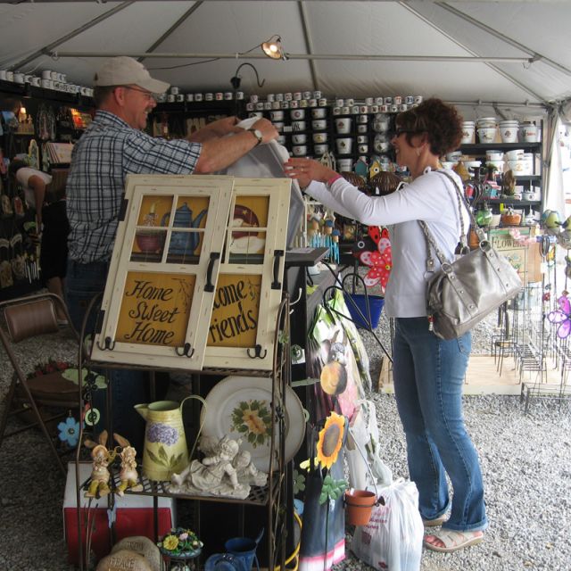 Happy vendor and happy shopper doing a transaction at Shipshewana Flea Market