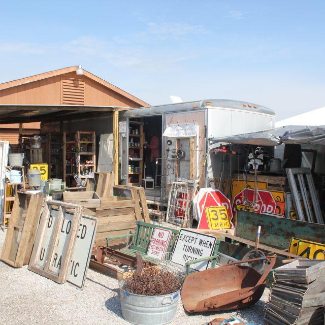 Road signs and antiques set up for sale at flea market in Shipshewana Indiana