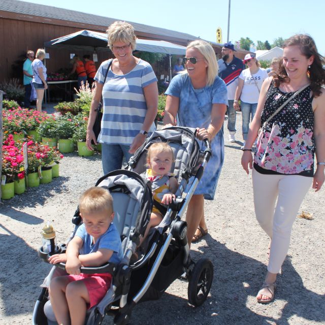 Family with two kids walking the plant aisle at flea market in Shipshewana, Indiana